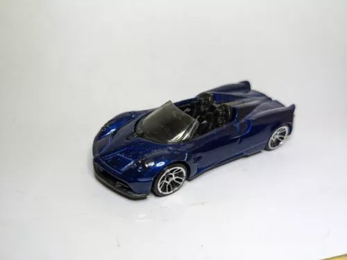 Blue diecast roadster car with black interior and silver wheels, 1:64 scale