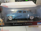 Blue 1948 Tucker Torpedo diecast car model, side view in display box