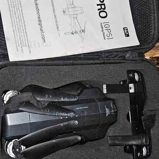 Black Ruko drone with built-in camera and attached controller parts