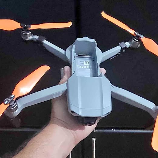 DJI Mavic Air 2 drone with four propellers, light gray body