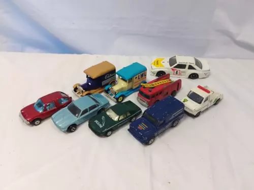 Vintage diecast toy car assortment with multiple cars in red, blue, green, white