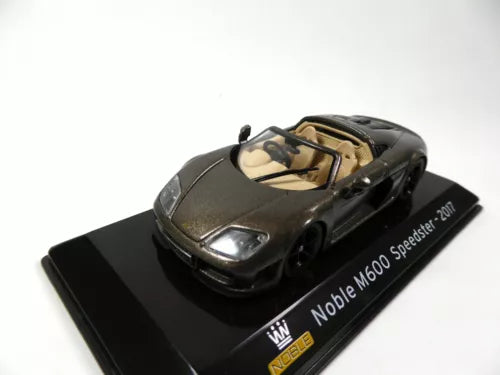 Noble M600 Speedster diecast car model in dark gray with front lights, on display base.