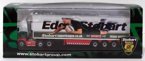 Diecast truck model with green and red graphics inside a clear display box