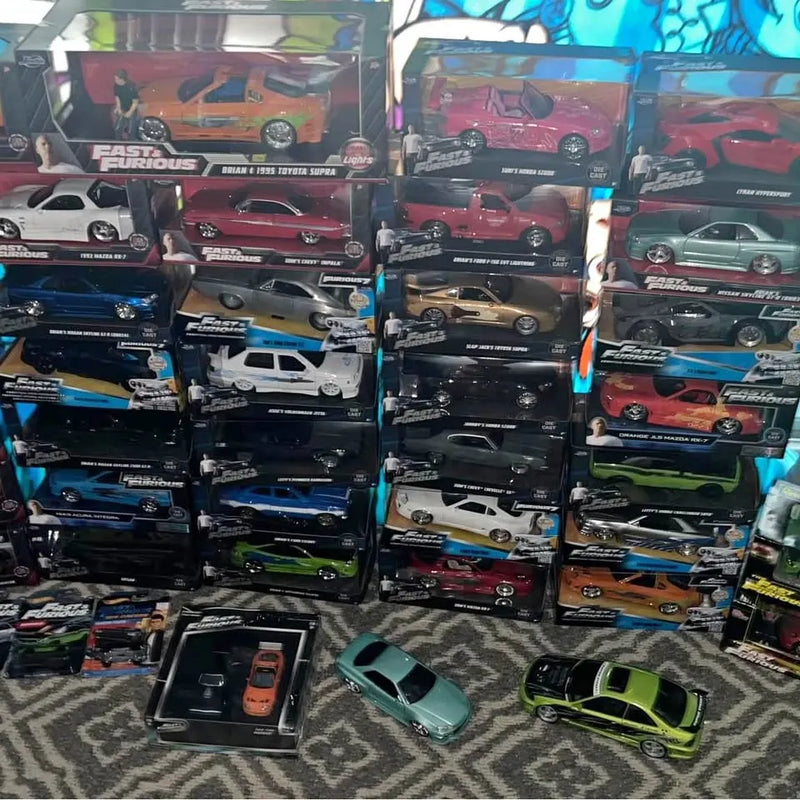 Diecast car lot with multiple boxed cars and several loose model cars on display