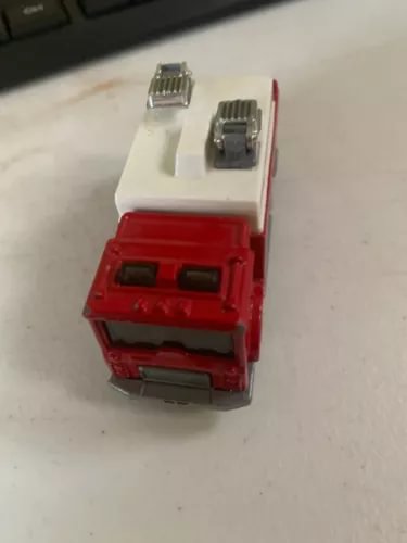 Red and white diecast auxiliary power truck cab detail, 1:84 scale, side view