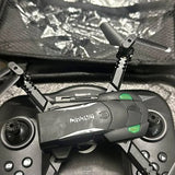 Grey drone with green indicator lights and four propellers