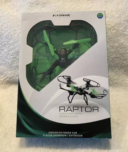 Green quadcopter drone with LED lights in retail box