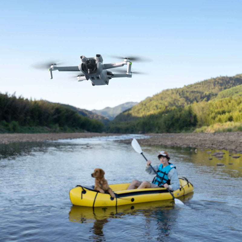 DJI Mini 3 quadcopter drone with camera, compact foldable design, hovering in flight