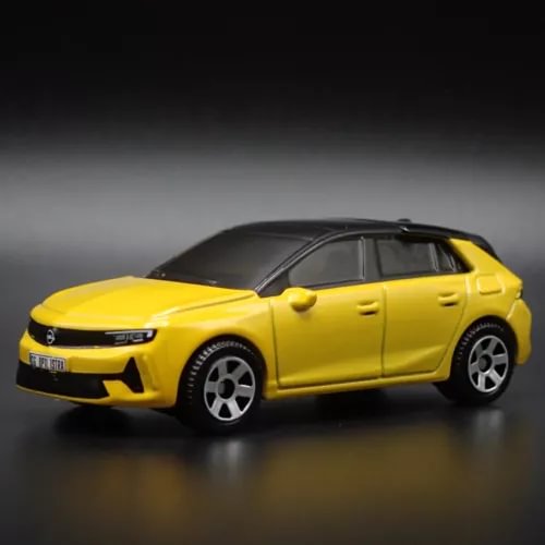 1:64 scale diecast model car, yellow 4-door sedan with black wheels