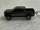 Diecast pickup truck keychain, dark green, side view with metal keyring