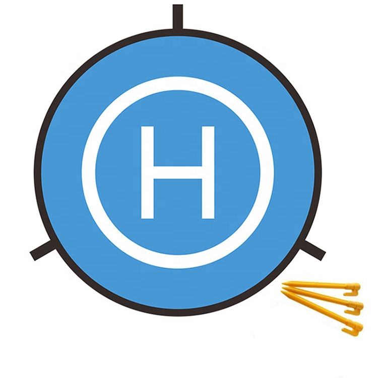 Blue circular drone landing pad mat with white H icon and foldable stakes