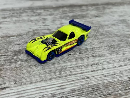 Neon yellow diecast race car with blue spoiler and black hood graphics