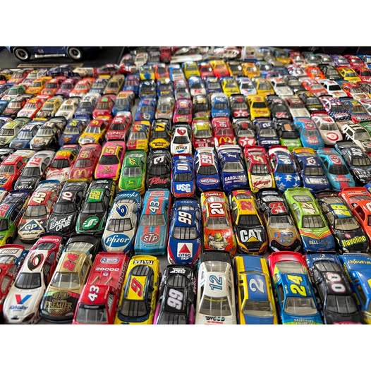 Sealed NASCAR diecast car lot in colorful display boxes, multiple cars