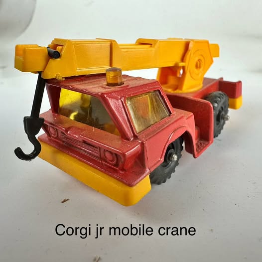 Vintage diecast mobile crane, red cab with yellow body and boom.