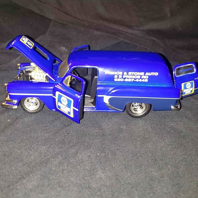 Blue diecast 1954 Chevrolet Sedan Delivery truck model, front 3/4 with open door.