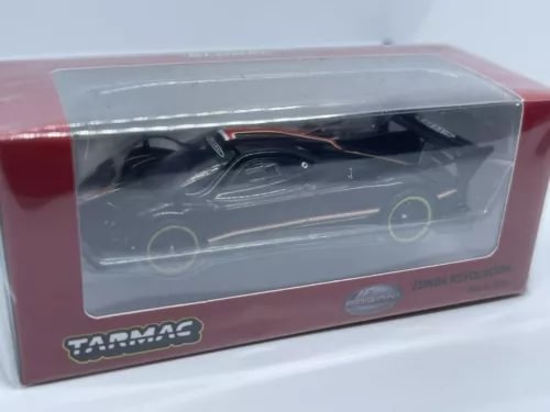 Diecast sports car model in display box, dark black with gold accents