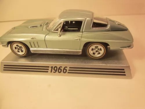 1966 diecast coupe model car in moss green, front three-quarter view on display base