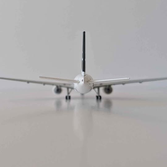 Diecast airplane model with nose and front landing gear, wings spread