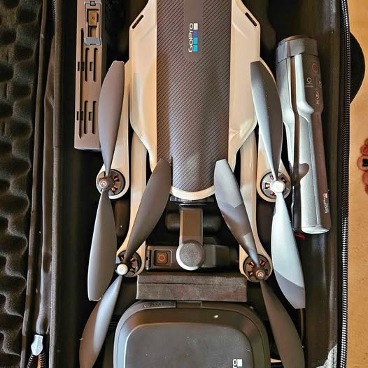 Folded quadcopter drone with four propellers and central camera module
