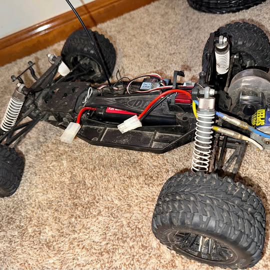 RC off-road buggy chassis with front suspension and large treaded wheels