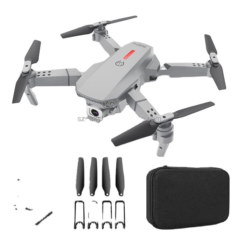 White RC quadcopter drone with four propellers, spare blades, and carrying case