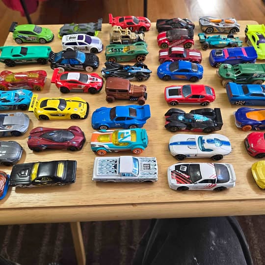 Diecast toy car lot, assorted colorful vehicles and trucks
