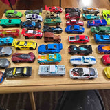 Diecast toy car lot, assorted colorful vehicles and trucks