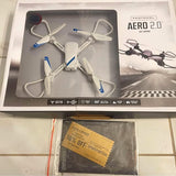 Remote-controlled quadcopter drone set in retail box, white with blue prop accents