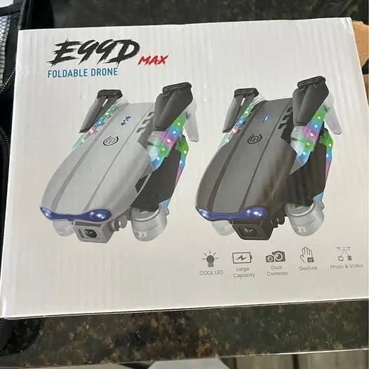 Foldable drone packaging with two grey drones, front LED lights and foldable arms