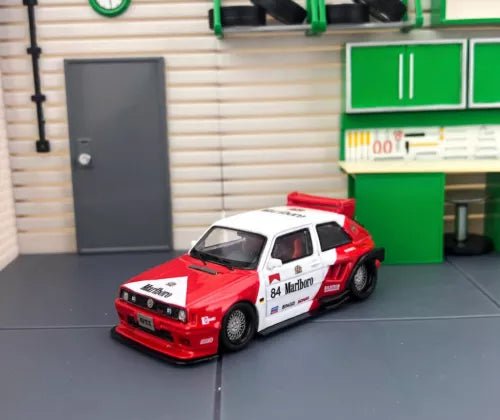 Red and white widebody racing diecast hatchback model car, front 3/4 view
