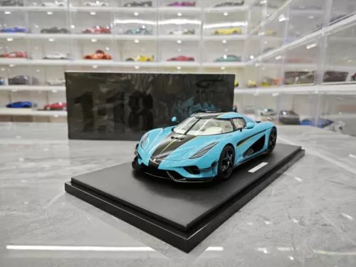 Baby blue diecast model car with black detailing on display base, front three-quarter view