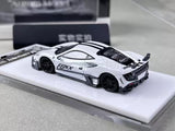 White diecast sports car model, black stripe hood, front and rear aero, on display base.
