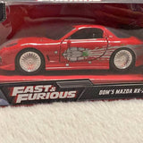Red diecast race car model with detailed engine graphic, on Fast & Furious display box