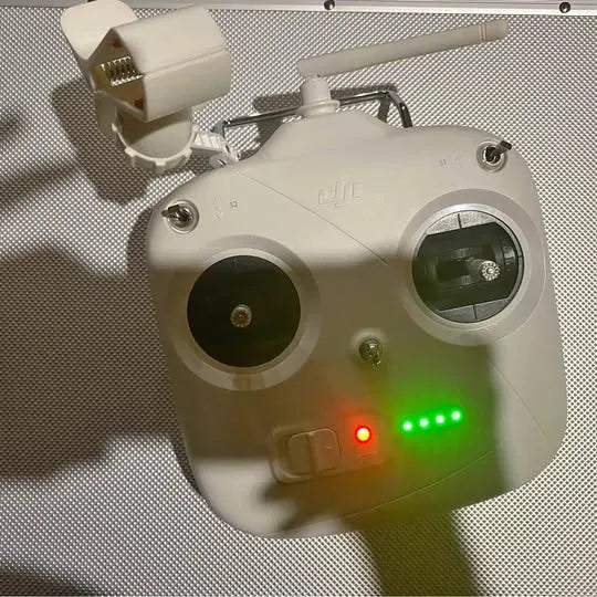 White DJI Phantom 3 remote controller with dual antenna and LED indicators