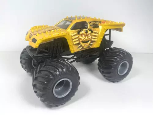 Diecast monster truck with yellow gold cab and black oversized tires
