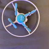 Kids drone with circular ring frame, blue propellers and light purple body