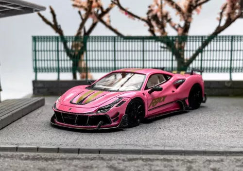 Pink racing sports diecast model car with black front splitter and racing decals