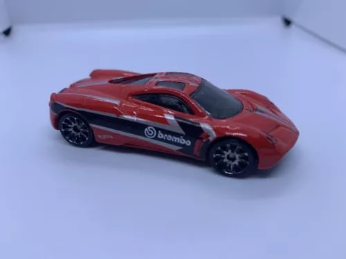 Diecast model car in red with black hood and Brembo logo, 1:64 scale racing styling
