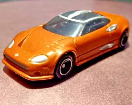 Tomica orange sports diecast car model with black wheels and clear windshield
