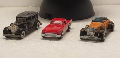 Diecast car set: black, red, and orange vintage cars, three vehicles