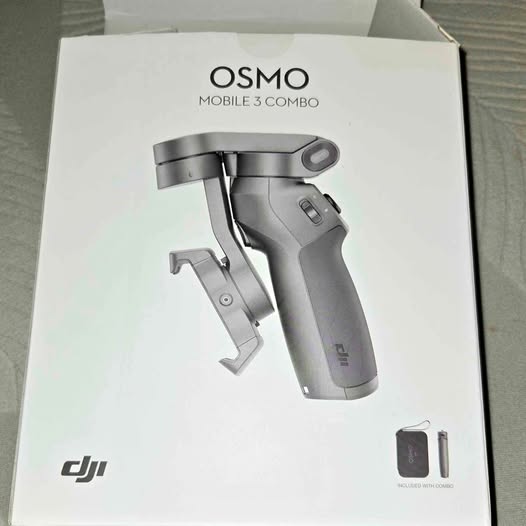 Handheld smartphone gimbal stabilizer in gray, shown on retail box packaging