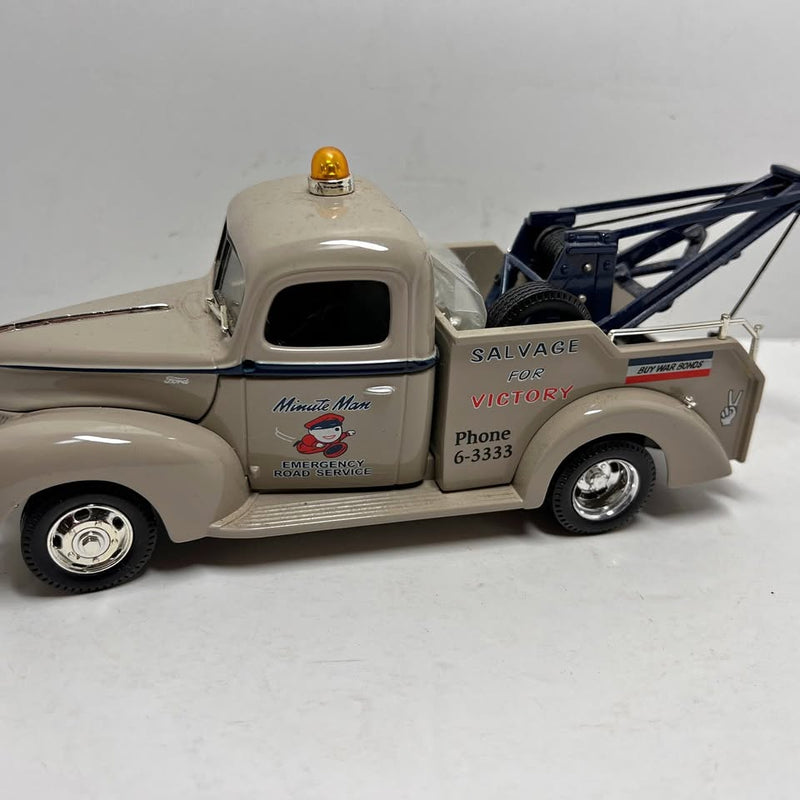 Gray diecast 1940 Ford wrecker truck with crane boom and side tow arm