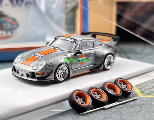 Silver diecast racing sports model car with orange and blue accents, front 3/4 view