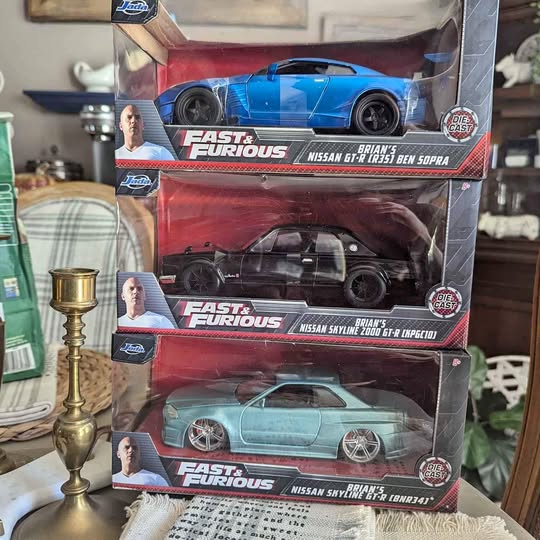 Fast & Furious diecast car set with blue, black, and teal cars in boxes