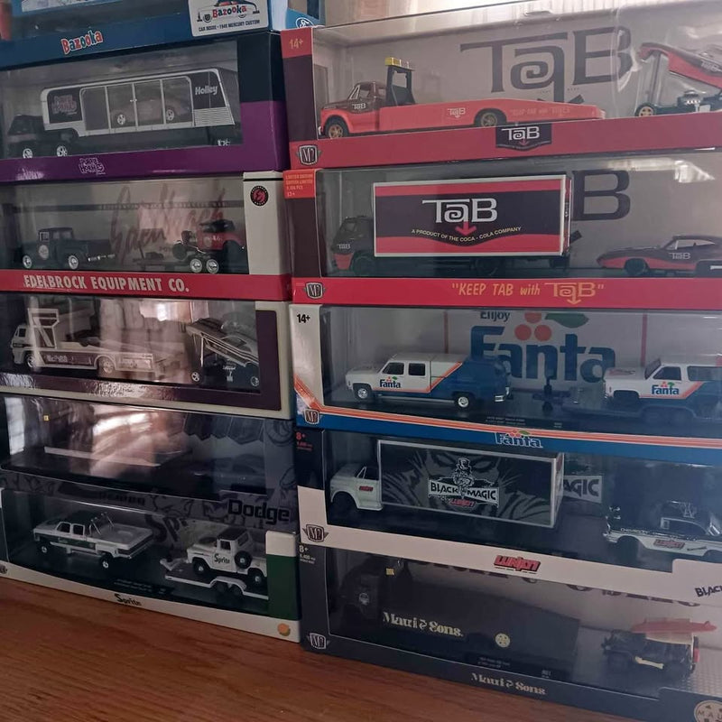 Die-cast hauler trucks in retail boxes with Ford, Dodge, and Chevy branding