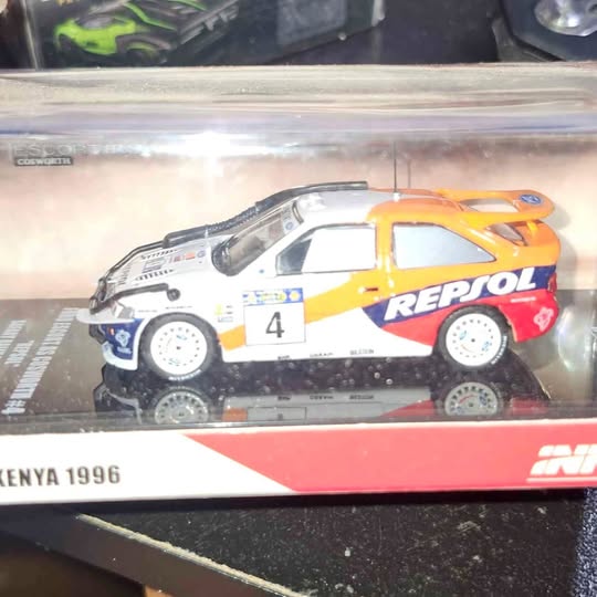 Diecast race car model with yellow, blue, and white livery, REPSOL logo