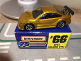 Gold Matchbox diecast car model with Opel Calibra DTM #66 livery