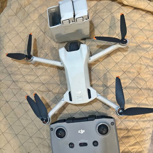 DJI Fly Mini 2 drone with remote controller, folded propellers and front lights