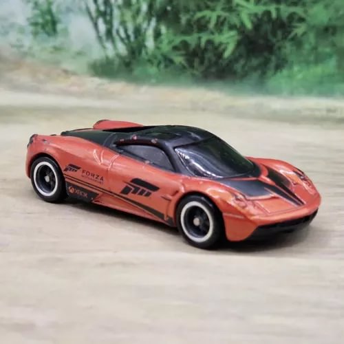 Orange and black diecast model car, 1/64 scale, sporty racing coupe