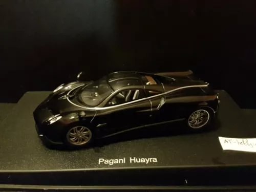 Diecast Pagani Huayra 2012 car, dark body with gold accents, front 3/4 view